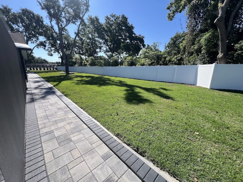 Side yard after landscaping - green lawn with paver walkway
