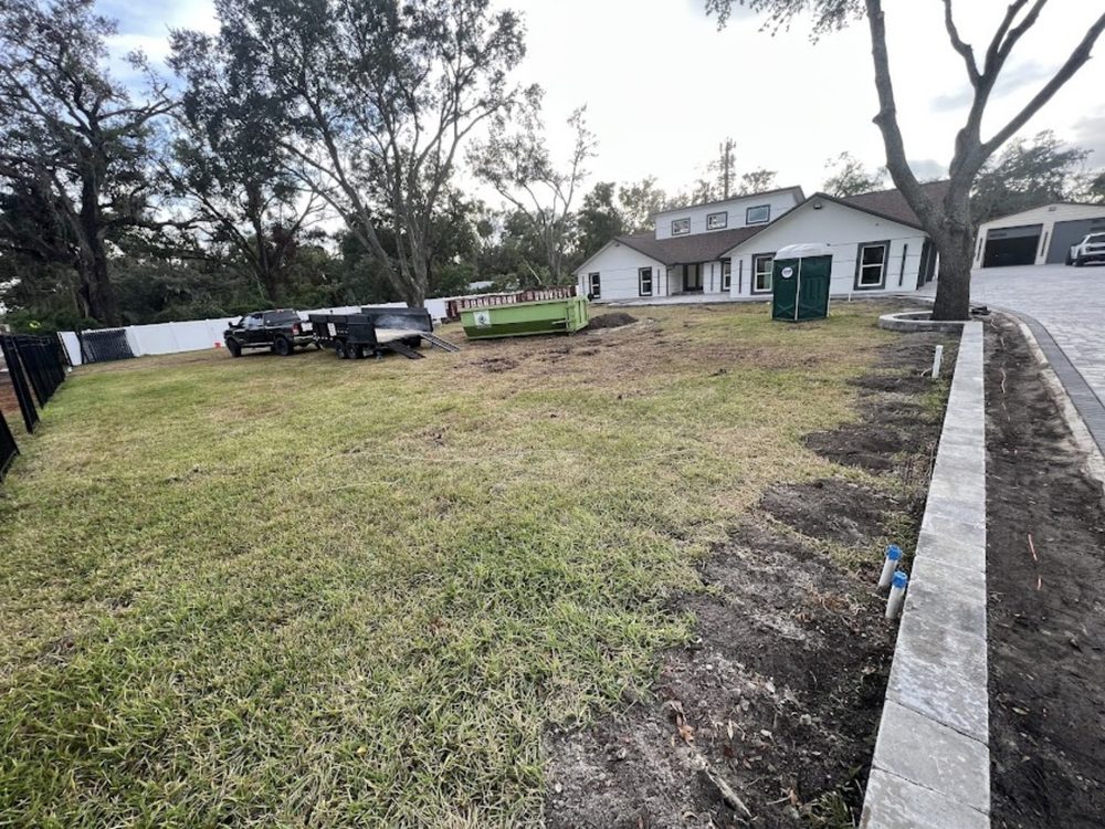 Yard before sod installation - bare dirt and construction debris