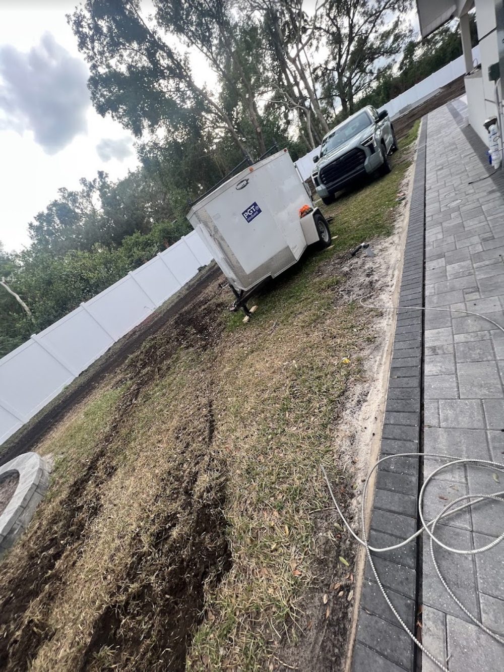 Side yard before landscaping - dirt and trailer