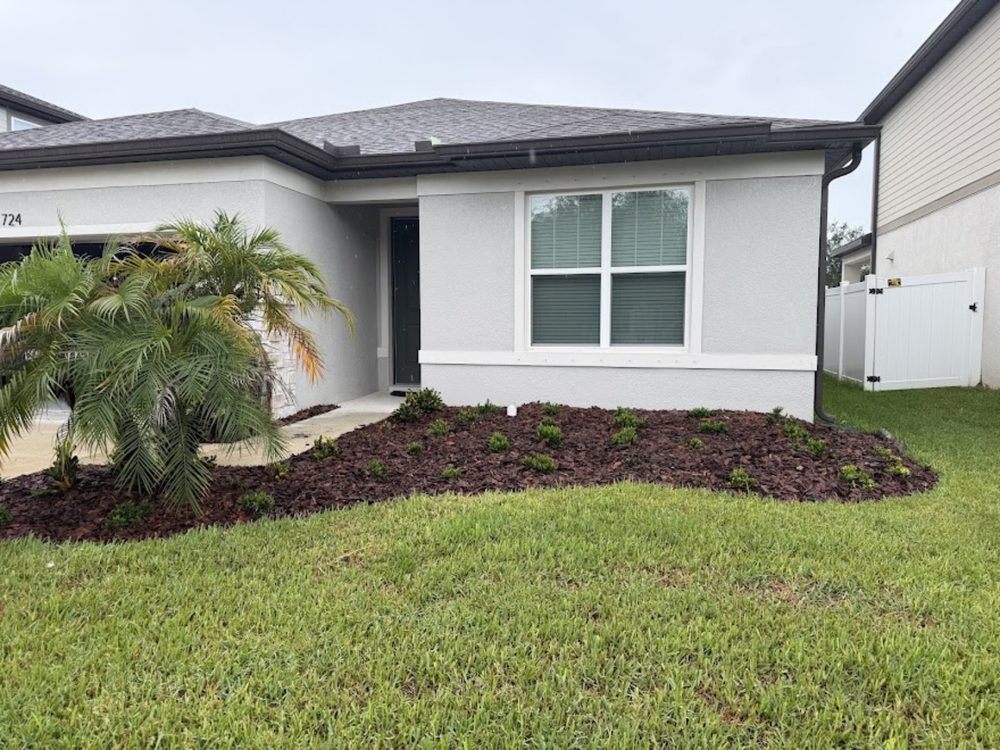 Fresh mulch bed and landscaping around a front yard